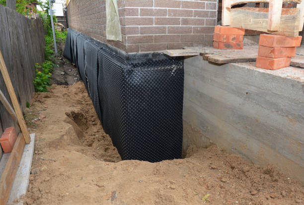Happy homeowners after waterproofing job in Burnett